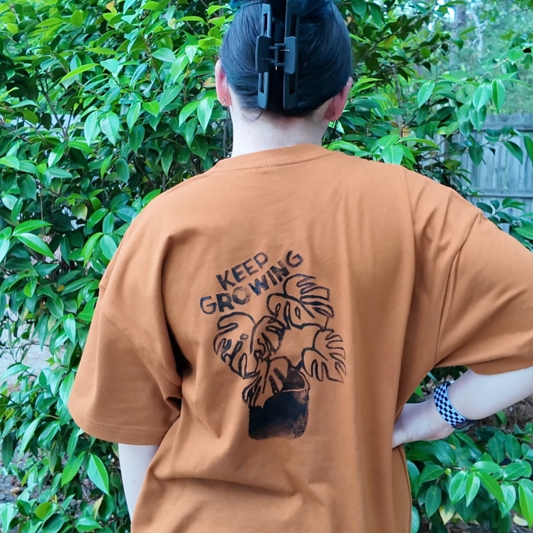 MADE TO ORDER 2-3WK TURNAROUND | Burnt Orange 'Keep Growing' Monstera Block Printed Baggy T-Shirt | Oversized | Hand-Inked | XS-3XL | Soft and Sensory Friendly | UNISEX |