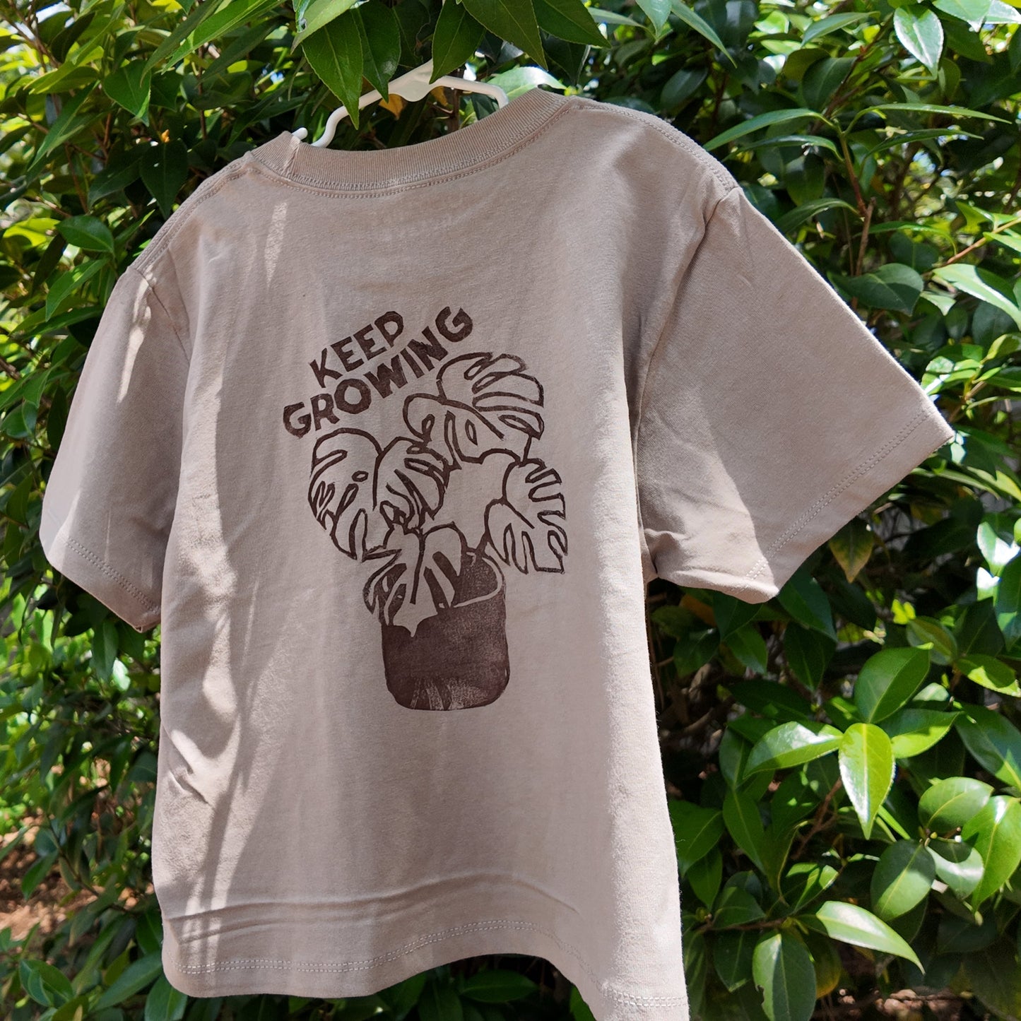 MADE TO ORDER 2-3WK TURNAROUND | Tan 'Keep Growing' Monstera Block Printed Boxy Cropped T-Shirt | Oversized | Hand-Inked | XS-3XL | Soft and Sensory Friendly | UNISEX |